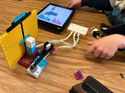 Young students building and coding a robot together at UP Robotics