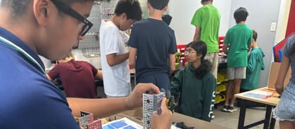 Students building and testing robots together in an UP Robotics class